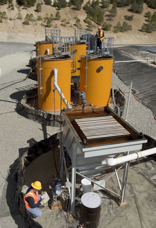 Treatment system with reaction tanks and clarifier at a mine site